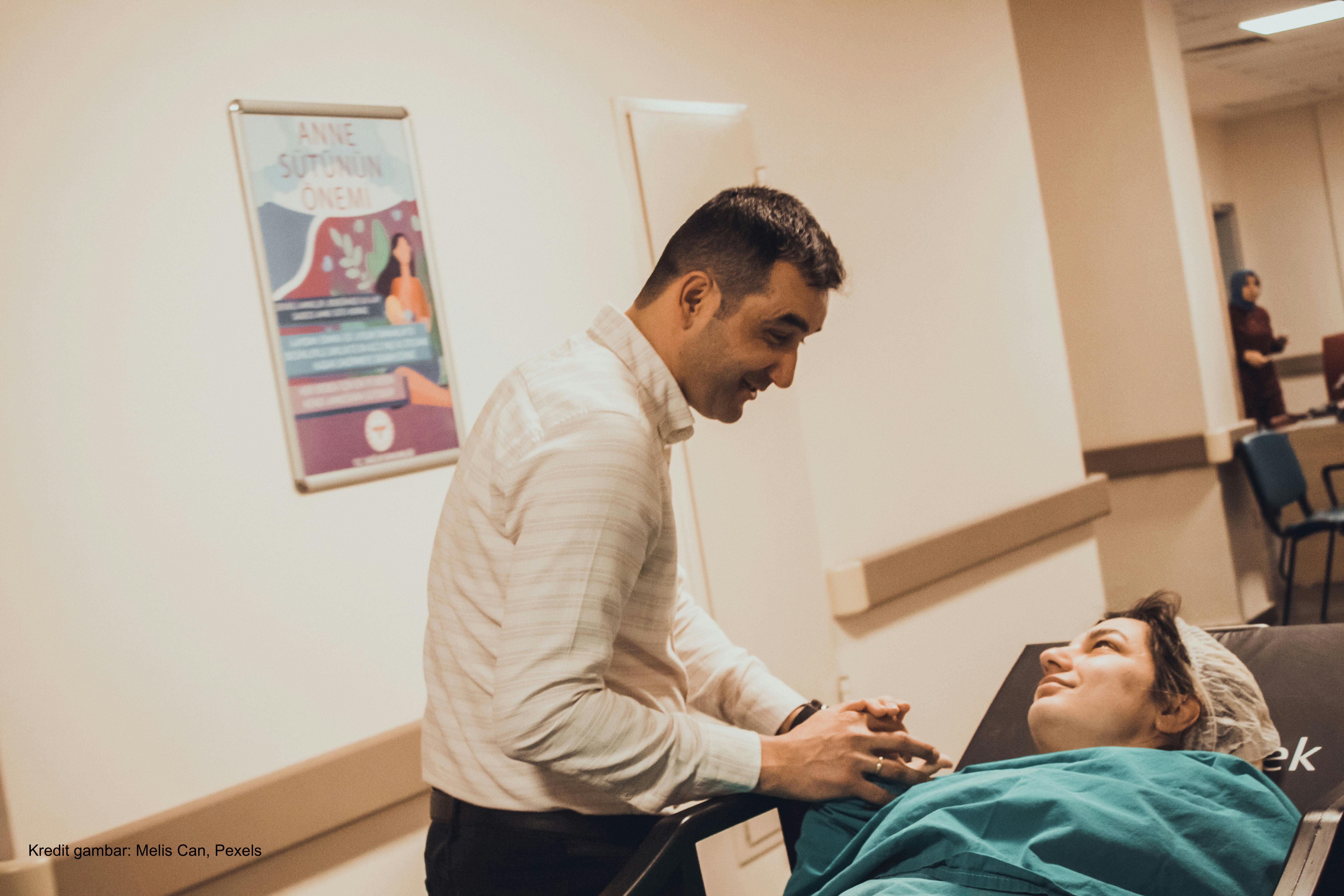 Man Supporting Woman Before Giving Birth
