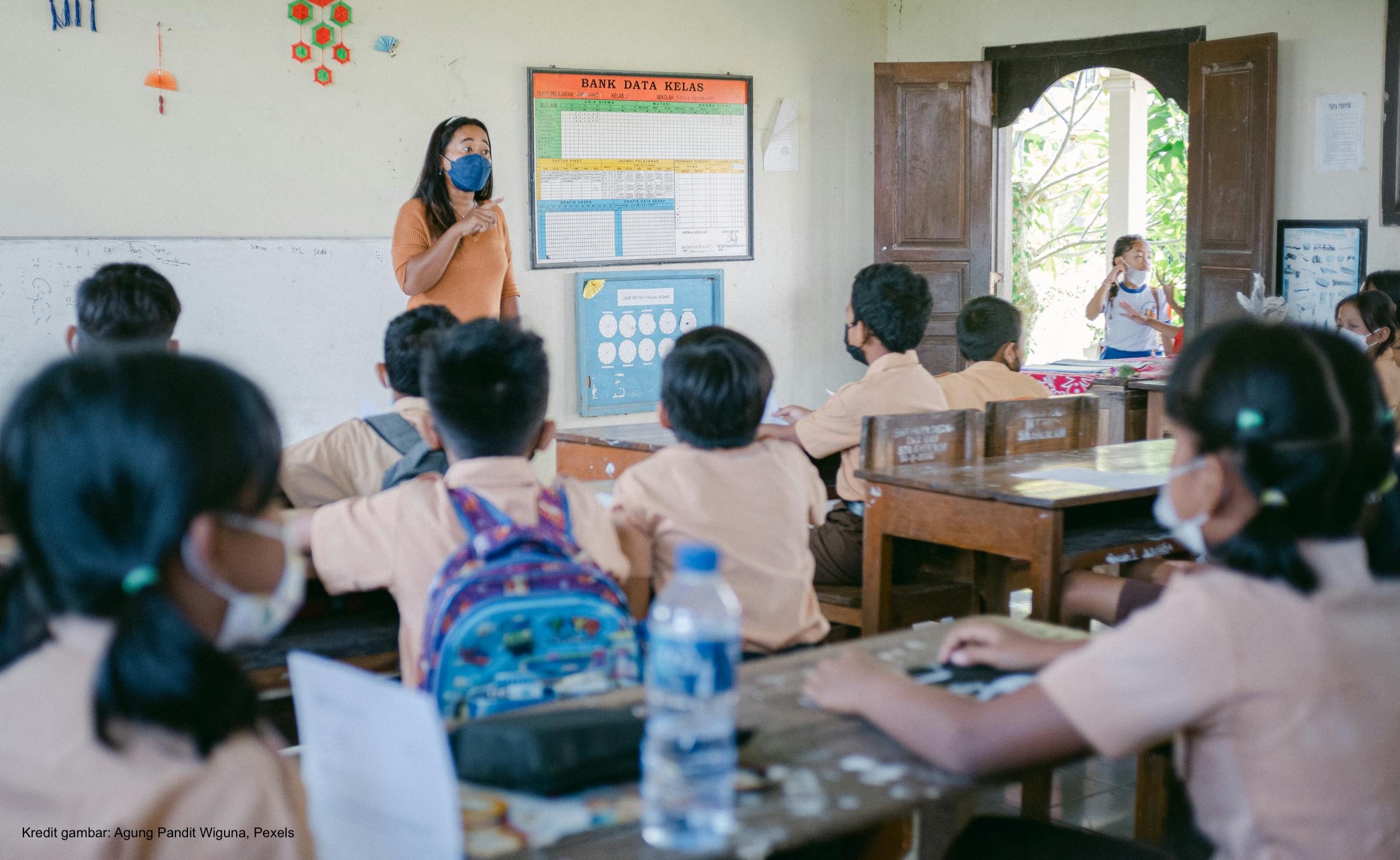 Woman Teaching Children in a Classroom